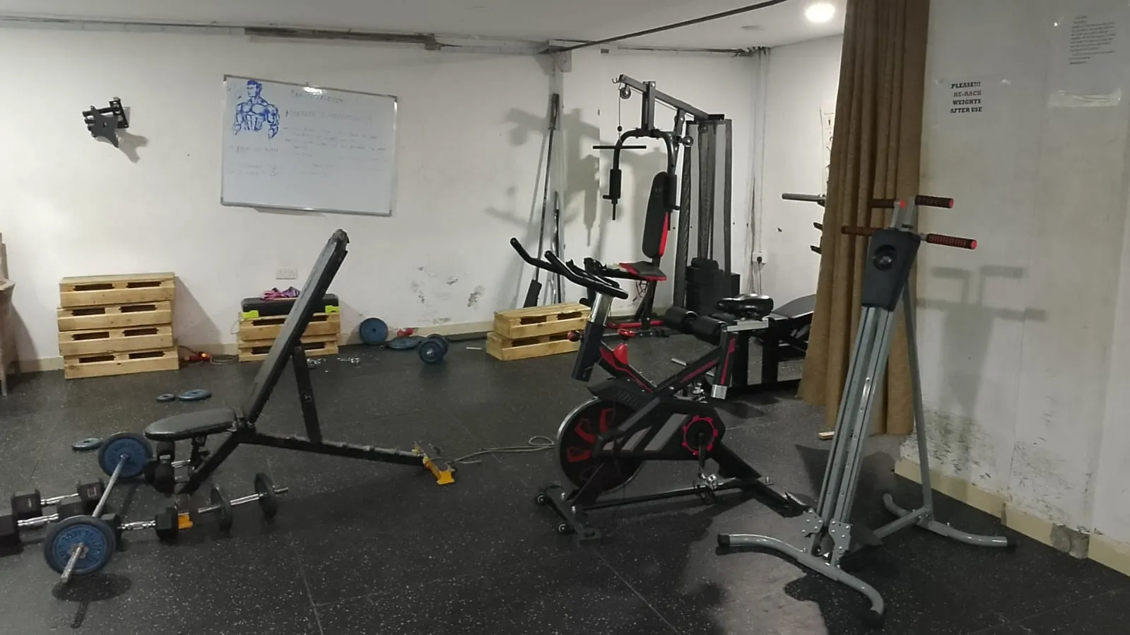 The gym at Generis Hotel with cardio and weight equipment